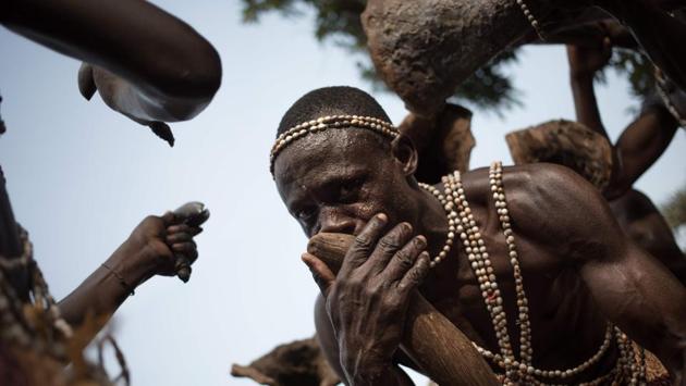 A Broto musician plays the horn in the middle of his troupe during a performance. The polyphonic sounds follow a score of extreme rhythmic precision. In olden times the art was transmitted to all from generation to generation as an initiation rite. Today, only the youngest receive training. (Florent Vergenes / AFP) A Broto musician plays the horn in the middle of his troupe during a performance. The polyphonic sounds follow a score of extreme rhythmic precision. In olden times the art was transmitted to all from generation to generation as an initiation rite. Today, only the youngest receive training. (Florent Vergenes / AFP)