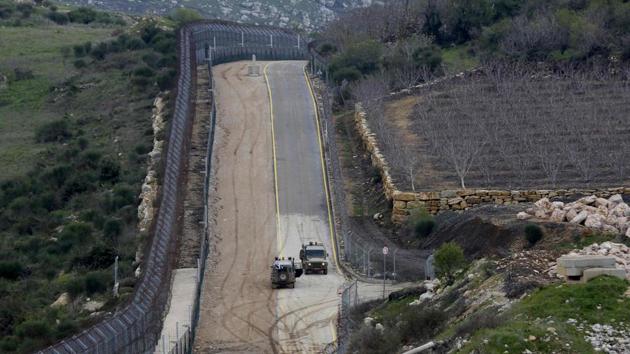 A picture taken on March 27 from the village of Majdal Shams in the Israeli-annexed Golan Heights shows Israeli military vehicles patrolling the border fence along the border with Syria.(AFP Photo) A picture taken on March 27 from the village of Majdal Shams in the Israeli-annexed Golan Heights shows Israeli military vehicles patrolling the border fence along the border with Syria.(AFP Photo)