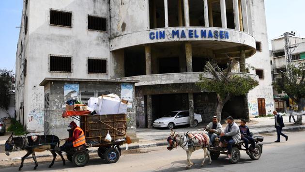 Gaza residents pass an abandoned cinema. Older residents remember watching Egyptian movies in cinemas during the 1960s, but from the 1980s on, fundamentalist Islamist groups burned down such places of public entertainment and closed liquor shops. (Dylan Martinez / REUTERS) Gaza residents pass an abandoned cinema. Older residents remember watching Egyptian movies in cinemas during the 1960s, but from the 1980s on, fundamentalist Islamist groups burned down such places of public entertainment and closed liquor shops. (Dylan Martinez / REUTERS)