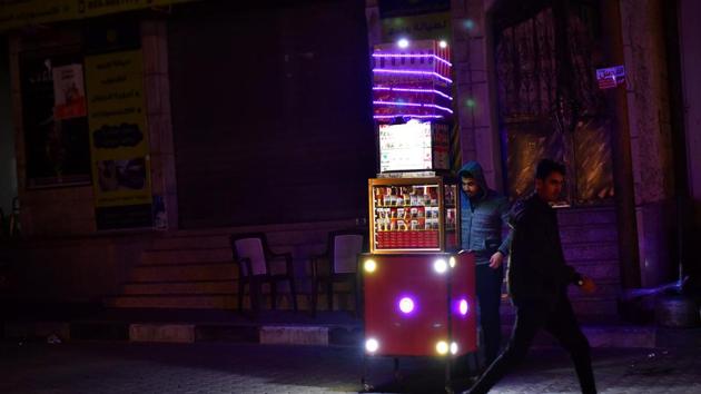A man sells cigarettes. The sellers sell individual cigarettes at one shekel apiece, or a little more than 25 US cents. After the sun goes down and the streets empty, pool halls and bakeries continue to operate through the darkness imposed by night, and by Gaza’s constant power cuts. (Dylan Martinez / REUTERS) A man sells cigarettes. The sellers sell individual cigarettes at one shekel apiece, or a little more than 25 US cents. After the sun goes down and the streets empty, pool halls and bakeries continue to operate through the darkness imposed by night, and by Gaza’s constant power cuts. (Dylan Martinez / REUTERS)