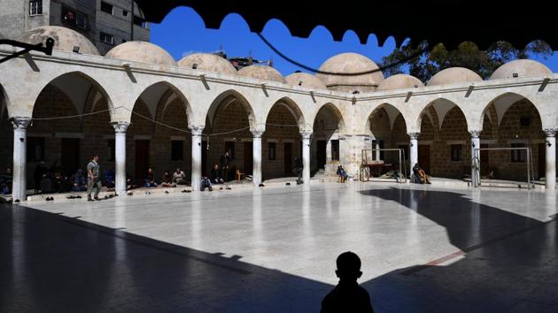 People arrive for prayer at Al Saeed Hashem Mosque in Gaza City. This mosque is the largest and oldest in Gaza, whose nearly 2 million population is overwhelmingly Sunni Muslim. (Dylan Martinez / REUTERS) People arrive for prayer at Al Saeed Hashem Mosque in Gaza City. This mosque is the largest and oldest in Gaza, whose nearly 2 million population is overwhelmingly Sunni Muslim. (Dylan Martinez / REUTERS)
