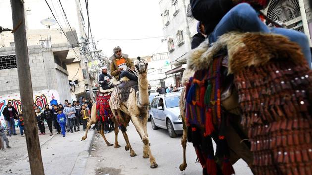 Bedouin jockeys parade their camels during a wedding party. Martinez did not know what to expect after he crossed through Israel’s fortified checkpoint, past a long caged walkway leading to a dilapidated Palestinian checkpoint. His remit, Martinez thought, was to do pretty much anything but capture the clashes. “Because everyone has seen that side of Gaza.” (Dylan Martinez / REUTERS) Bedouin jockeys parade their camels during a wedding party. Martinez did not know what to expect after he crossed through Israel’s fortified checkpoint, past a long caged walkway leading to a dilapidated Palestinian checkpoint. His remit, Martinez thought, was to do pretty much anything but capture the clashes. “Because everyone has seen that side of Gaza.” (Dylan Martinez / REUTERS)