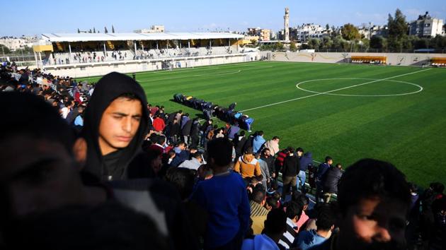 Football fans and officials pray during half-time during a match between Rafah, from south Gaza, and their rivals Beit Hanoun during a soccer match. Gaza seemed evenly split between Real Madrid and Barcelona fans, but local rivalries also run deep, with some matches having to be played on neutral grounds. Palestine currently stands 100 in the FIFA world rankings, eight places behind Israel. (Dylan Martinez / REUTERS) Football fans and officials pray during half-time during a match between Rafah, from south Gaza, and their rivals Beit Hanoun during a soccer match. Gaza seemed evenly split between Real Madrid and Barcelona fans, but local rivalries also run deep, with some matches having to be played on neutral grounds. Palestine currently stands 100 in the FIFA world rankings, eight places behind Israel. (Dylan Martinez / REUTERS)