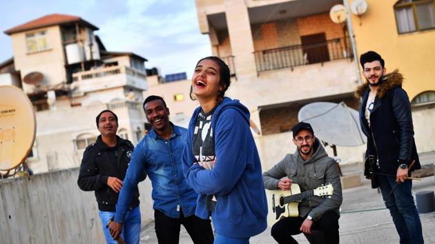 Singer Rahaf Shamali, 15, Hamada Nasralla, 23, Ismaiel Al H'Razin, 42, Islam Mohsen, 24, and Saied Fadel of “Solband” pose on the roof of their apartment block in Gaza City. Martinez was warned many times by officials and bystanders on the street, in a more cautionary than menacing manner, not to photograph Hamas checkpoints and military installations. (Dylan Martinez / REUTERS) Singer Rahaf Shamali, 15, Hamada Nasralla, 23, Ismaiel Al H'Razin, 42, Islam Mohsen, 24, and Saied Fadel of “Solband” pose on the roof of their apartment block in Gaza City. Martinez was warned many times by officials and bystanders on the street, in a more cautionary than menacing manner, not to photograph Hamas checkpoints and military installations. (Dylan Martinez / REUTERS)