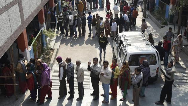 New Delhi, India - Feb. 7, 2015: People waiting in a long queue to cast their vote during the Delhi Assembly Elections, in New Delhi, India, on Saturday, February 7, 2015. (Photo by Sonu Mehta/ Hindustan Times)(Hindustan Times)
