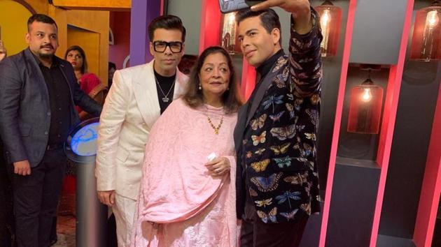 Karan Johar poses with his wax statue and mom Hiroo . Karan Johar poses with his wax statue and mom Hiroo .