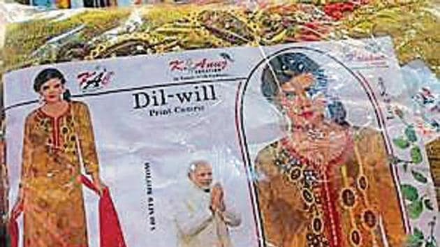 Apart from the BJP’s symbol, party slogans such as ‘acche din aane wale hai’ were also found on some packages.(HT Photo) Apart from the BJP’s symbol, party slogans such as ‘acche din aane wale hai’ were also found on some packages.(HT Photo)