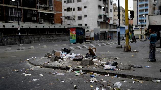 High-rise buildings stand unfinished, the workers having long ago abandoned their jobs. Windows are covered over with cardboard rather than finished with glass. The poor and hungry scour through household trash, scattering it across street corners before it’s collected, grabbing anything they can use or eat. (Natacha Pisarenko / AP) High-rise buildings stand unfinished, the workers having long ago abandoned their jobs. Windows are covered over with cardboard rather than finished with glass. The poor and hungry scour through household trash, scattering it across street corners before it’s collected, grabbing anything they can use or eat. (Natacha Pisarenko / AP)