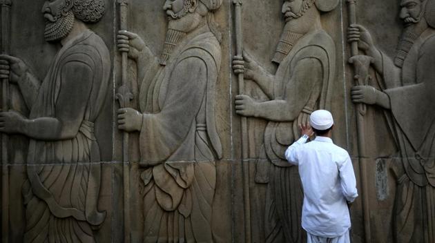 A man touches the wall of a Parsi fire temple. A newsletter of the Parsi community has been banned by the Bombay Parsi Punchayet after it published reports on alleged corruption in property deals linked to the BPP.(Reuters File)