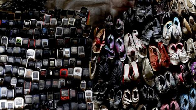 Used shoes and cell phones fill a wall at a market set up by residents under a road bridge. (Natacha Pisarenko / AP) Used shoes and cell phones fill a wall at a market set up by residents under a road bridge. (Natacha Pisarenko / AP)