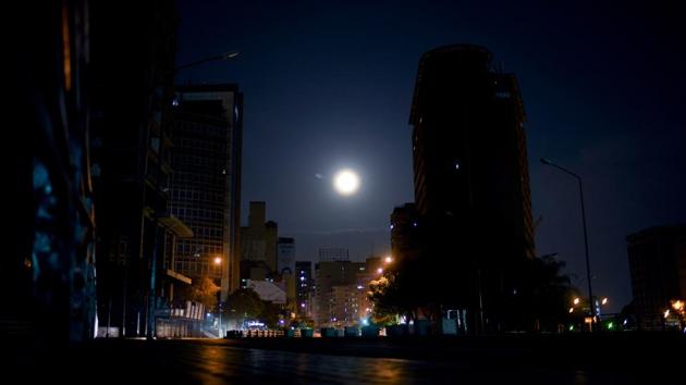 The moon rises above an empty avenue in Caracas. Many street lights don’t work. A string of devastating nationwide blackouts last month dramatized the decay. (Natacha Pisarenko / AP) The moon rises above an empty avenue in Caracas. Many street lights don’t work. A string of devastating nationwide blackouts last month dramatized the decay. (Natacha Pisarenko / AP)