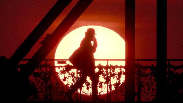 The sun rises behind the ‘Eiserne Steg’ (Iron Footbridge) pedestrian bridge in Frankfurt, Germany. (Michael Probst / AP) The sun rises behind the ‘Eiserne Steg’ (Iron Footbridge) pedestrian bridge in Frankfurt, Germany. (Michael Probst / AP)