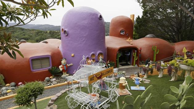 An exterior view of the Flintstone House. The San Francisco Bay Area suburb of Hillsborough is suing the owner of the house, saying that she installed dangerous steps, dinosaurs and other Flintstone-era figurines without necessary permits.(AP)