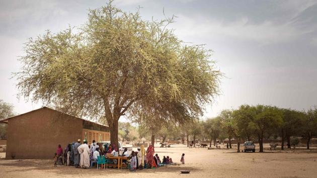 People gather during a vaccine drive operated by the health authorities supported by the French NGO Première Urgence Internationale (PUI) in the village of Agang in the Ouaddai highlands region of eastern Chad, bordering west Sudan. (Amaury Hauchard / AFP) People gather during a vaccine drive operated by the health authorities supported by the French NGO Première Urgence Internationale (PUI) in the village of Agang in the Ouaddai highlands region of eastern Chad, bordering west Sudan. (Amaury Hauchard / AFP)