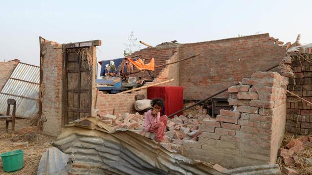 A child sits on her rubble of her damaged home at Bhaluhi Bharbaliya village in Nepal's southern Bara district near Birgunj, the morning after a rare spring storm. (Prakash Mathema / AFP) A child sits on her rubble of her damaged home at Bhaluhi Bharbaliya village in Nepal's southern Bara district near Birgunj, the morning after a rare spring storm. (Prakash Mathema / AFP)