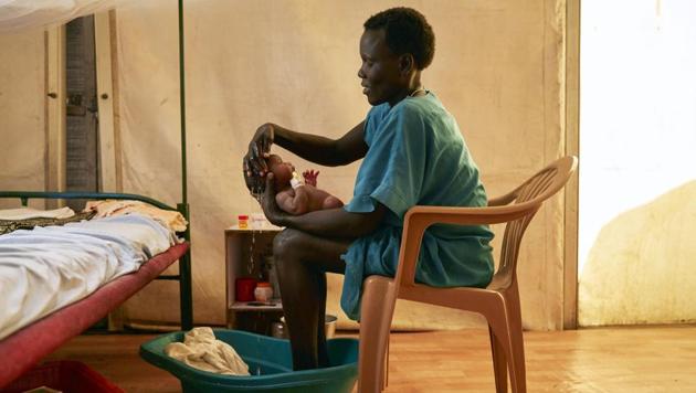 A mother washes her newborn infant at an Medecins Sans Frontieres (MSF) hospital in a protection of civilian site in Malakal, South Sudan. Some 30,000 internally displaced people continue to inhabit the camp in the north of the country despite the signing of a cessation of hostilities between government and opposition forces last year. (Alex Mcbride / AFP) A mother washes her newborn infant at an Medecins Sans Frontieres (MSF) hospital in a protection of civilian site in Malakal, South Sudan. Some 30,000 internally displaced people continue to inhabit the camp in the north of the country despite the signing of a cessation of hostilities between government and opposition forces last year. (Alex Mcbride / AFP)