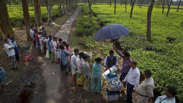 A woman casts her vote on a demo electronic voting machine and checks on Voter Verifiable Paper Audit Trail or VVPAT as others wait in the queue during an election awareness drive among tea garden labourers in Jorhat, Assam. (Anupam Nath / AP) A woman casts her vote on a demo electronic voting machine and checks on Voter Verifiable Paper Audit Trail or VVPAT as others wait in the queue during an election awareness drive among tea garden labourers in Jorhat, Assam. (Anupam Nath / AP)