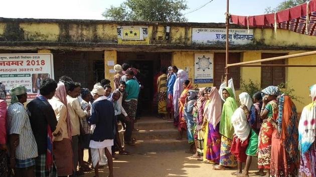 Chhattisgarh, India- November 12, 2018: People queue outside a polling station to cast their vote during the first phase of the Chhatisgarh assembly elections at Sukma district on Monday, November 12, 2018. The first phase of elections for 18 seats are spread across eight Maoist-affected districts with nearly one lakh security personnel deployed amid threats from Maoist who have called for boycott of the elections. (HT Photo)