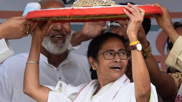 West Bengal Chief Minister Mamata Banerjee being presented with a 'Jaapi' (traditional hat of Assam) by the party supporters during the public meeting at Dhubri on Friday.(ANI) West Bengal Chief Minister Mamata Banerjee being presented with a 'Jaapi' (traditional hat of Assam) by the party supporters during the public meeting at Dhubri on Friday.(ANI)