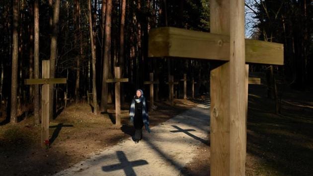 A woman walks past crosses at the site where the Soviet secret police shot and buried thousands of victims of the political repressions in the 1930s and 1940s. Authorities are working to demolish the illegal structures. (Sergei Gapon / AFP) A woman walks past crosses at the site where the Soviet secret police shot and buried thousands of victims of the political repressions in the 1930s and 1940s. Authorities are working to demolish the illegal structures. (Sergei Gapon / AFP)
