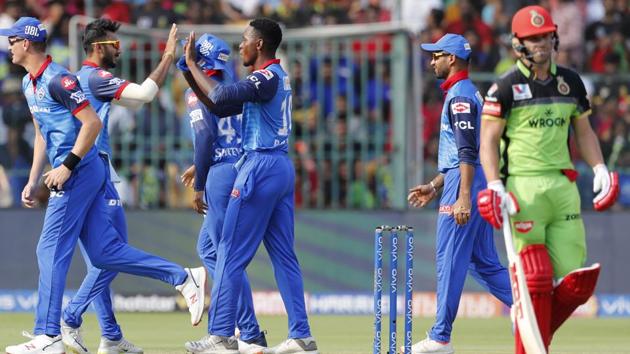 Delhi Capitals' Kagiso Rabada, center without cap, celebrates with teammates the dismissal of Royal Challengers Bangalore's AB de Villiers. (AP)