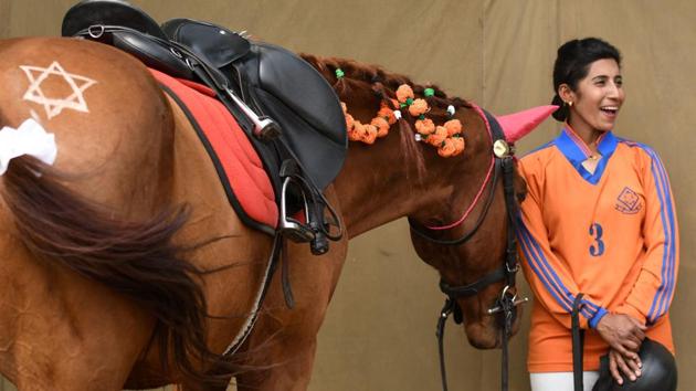 A Nepalese Army personnel smiles as she stands near a decorated horse during the Ghode Jatra in Kathmandu. According to a centuries-old tradition, people raced horses before worshipping gods with offerings of food and flowers under a tree. It has been 169 years since a Nepalese king designated the army to perform the festival rituals. (Prakash Mathema / AFP) A Nepalese Army personnel smiles as she stands near a decorated horse during the Ghode Jatra in Kathmandu. According to a centuries-old tradition, people raced horses before worshipping gods with offerings of food and flowers under a tree. It has been 169 years since a Nepalese king designated the army to perform the festival rituals. (Prakash Mathema / AFP)