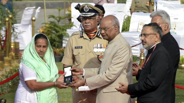 President Ram Nath Kovind hands a medal to a family member of a fallen soldier during a remembrance service that marks the annual “Valour Day” event of the Central Reserve Police Force (CRPF). Kovind paid tributes to the police and paramilitary personnel killed in the line of duty, including the 40 CRPF men killed in the February 14 Pulwama terror attack, at the National Police Memorial. (Sushil Kumar / HT Photo)