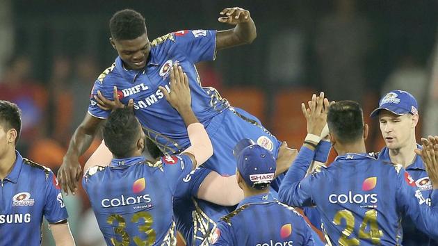 Mumbai Indian team members lift Alzarri Joseph after winning the match against the Sunrisers Hyderabad.(AP)