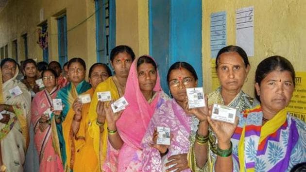 Karad: Voters show their identity cards as they stand in a queue at a polling station to cast their vote for the Gram Panchayat elections at Masur village, in Karad, Sunday, Feb. 24, 2019. (PTI Photo)(PTI2_24_2019_000044B)(PTI)