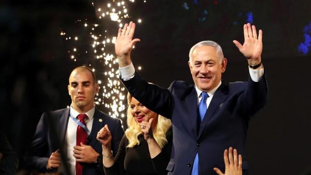 Israeli Prime Minister Benjamin Netanyahu and his wife Sara react as they stand on stage following the announcement of exit polls in Israel's parliamentary eJerusalemlection at the party headquarters in Tel Aviv, Israel April 10, 2019. REUTERS/Ammar Awad(REUTERS)
