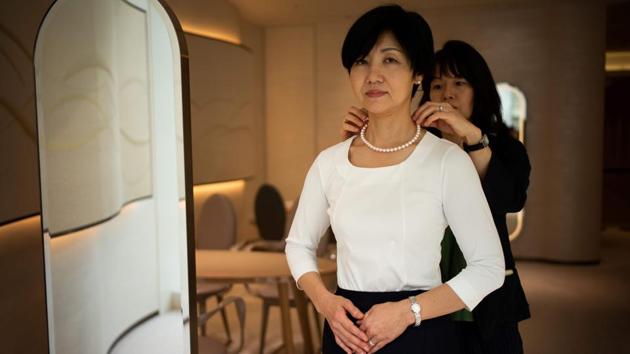 An employee of Mikimoto jewellery tries a necklace made of cultured Akoya pearls. Rivals from China at one point looked set to threaten Japan’s dominance but “they focused in quantity... whereas we concentrated on quality.” That quality is on glittering display at the flagship Mikimoto store in Tokyo. Pearls here can range from a few hundred to a million dollars. (Martin Bureau / AFP)