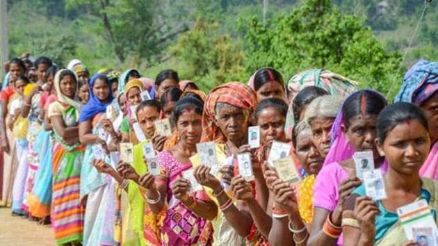 Silli: Voters show their identity cards as they wait in a queue to cast their votes for Silli Assembly bypolls, at a polling station, in Silli on Monday. PTI Photo (PTI5_28_2018_000179B)(PTI)