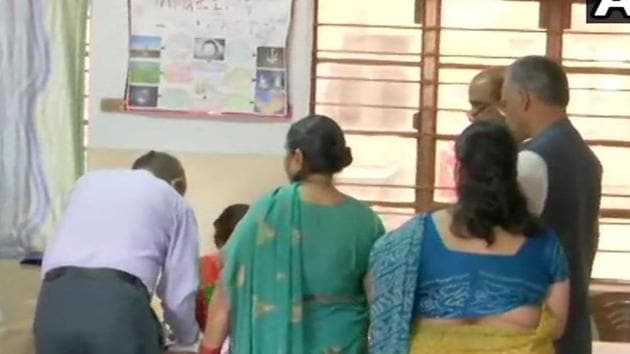 Uttarakhand chief minister Trivendra Singh Rawat (extreme right, in grey jacket) at a polling booth to cast his vote in Dehradun, April 11, 2019. (ANI / Twitter) Uttarakhand chief minister Trivendra Singh Rawat (extreme right, in grey jacket) at a polling booth to cast his vote in Dehradun, April 11, 2019. (ANI / Twitter)