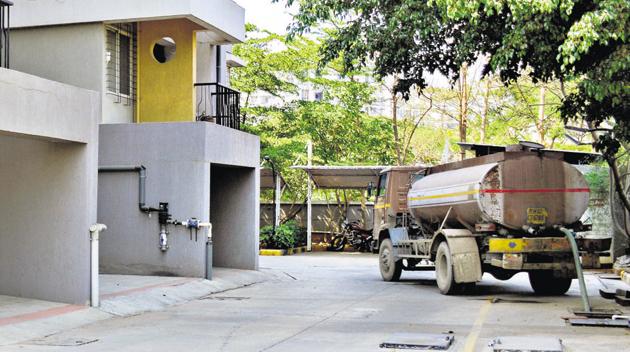 Residents are becoming increasingly dependent on water tankers for their daily needs. One such society at Hinjewadi on Wednesday.(Milind Saurkar/HT Photo)