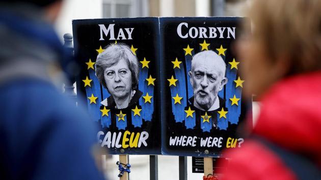 Pedestrians walk past placards featuring Britain's Prime Minister Theresa May and opposition Labour party leader Jeremy Corbyn near the Houses of Parliament in central London on April 3, 2019. (AFP file photo) Pedestrians walk past placards featuring Britain's Prime Minister Theresa May and opposition Labour party leader Jeremy Corbyn near the Houses of Parliament in central London on April 3, 2019. (AFP file photo)