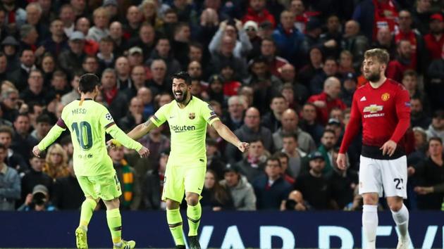 Barcelona's Luis Suarez celebrates scoring their first goal with Lionel Messi and Manchester United's Luke Shaw reacts(Action Images via Reuters)
