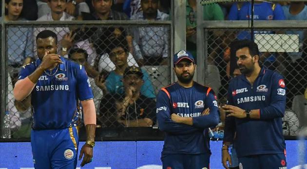 Mumbai Indians cricketer and stand-in captain Kieron Pollard (L) looks on as Mumbai Indians captain Rohit Sharma (C) talks with team technical director cricket operations, Zaheer Khan (R) during the 2019 Indian Premier League (IPL) Twenty20 cricket match between Mumbai Indians and Kings XI Punjab at the Wankhede cricket stadium in Mumbai on April 10, 2019(AFP)