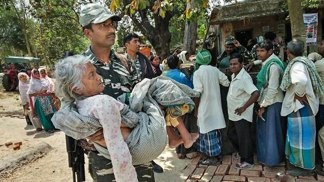A CRPF personnel carries an elderly woman to a polling station in Gaya. An estimated 13.73% voting was recorded in the first three hours of polling that began amid tight security in four Lok Sabha seats in Bihar. Few incidents of EVM malfunctioning were reported in some booths under Nawada Lok Sabha constituency, and a cane bomb was found at a polling station in Gaya district before voting began at 7 am. (PTI) A CRPF personnel carries an elderly woman to a polling station in Gaya. An estimated 13.73% voting was recorded in the first three hours of polling that began amid tight security in four Lok Sabha seats in Bihar. Few incidents of EVM malfunctioning were reported in some booths under Nawada Lok Sabha constituency, and a cane bomb was found at a polling station in Gaya district before voting began at 7 am. (PTI)
