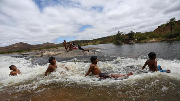 Macuxi children play in Uailan River at the community of Uailan. Younger tribe members say they would fight for the land, among them Tiago Nunes Pereira, 24, who bore scars on his leg from a gunshot wound in a clash with farmers when he was just 12 years old. “Blood was shed here. That hurt a lot. I’m not scared to die. We will never tire of fighting, to the last one of us.” (Bruno Kelly / REUTERS)