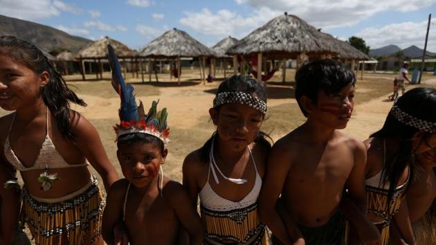 Macuxi children dance a ceremony for indigenous leaders. The Macuxi fear the return of illegal gold miners and other poachers, emboldened by Bolsonaro’s rhetoric and his moves to weaken their rights. “It is the richest area in the world. There are ways to exploit it rationally. And for the Indians, to give them royalties and integrate them into society,” he said in December. (Bruno Kelly / REUTERS)