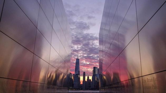 Framed through the Empty Sky Memorial in Jersey City, New Jersey, sunrise lights up the sky behind the New York City skyline. (/J. David Ake / AP) 