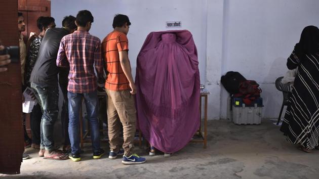 Uttar Pradesh, India-April 11, 2019: Voters stand in a to cast their votes at a polling station during the first phase of the Lok Sabha elections, at Shahpur, Muzaffarnagar, in Uttar Pradesh, India, on Thursday, April 11, 2019. (Photo by Raj K Raj/ Hindustan Times)(Raj K Raj/HT PHOTO)