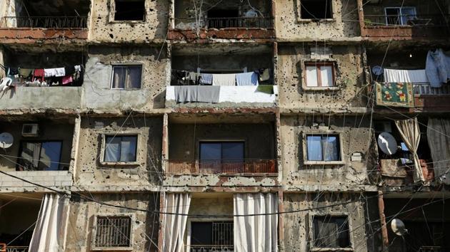 An inhabited building that is still riddled with bullets and shells left over from the civil war. Not everyone feels the same. A woman who rents an apartment in a bullet-scarred building on the former Green Line between the mainly Muslim Shiyah and Christian Ayn el Rummaneh districts, said she worries about her two sons and society judging them for where they live. (Hassan Ammar / AP)