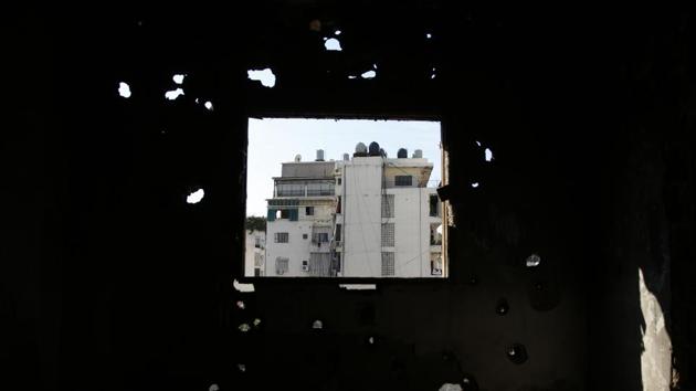 Shiyah, a Muslim Shiite neighbourhood is seen from a destroyed apartment in the southern Beirut Christian district of Ain el-Rummaneh, Lebanon. The two sides fought fierce battles during the 1975-90 civil war, which started with a shooting on a bus in Ain el-Rummaneh. (Hassan Ammar / AP)
