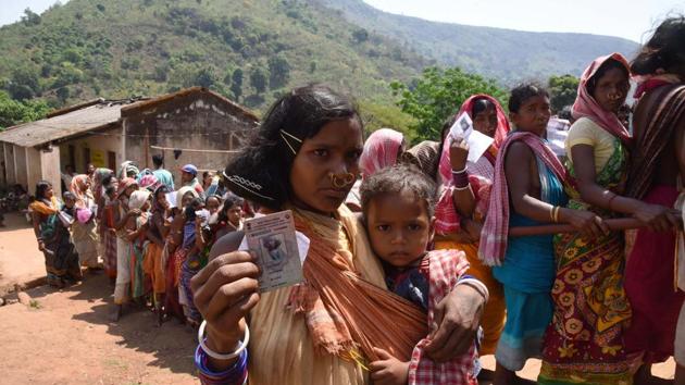 A woman belonging to the Dongria Kondh community stands in a queue ahead of casting her vote, in Rayagada district, Odisha. The turnout in the first phase of the 2014 election was 70%. (Arabinda Mahapatra / HT Photo)