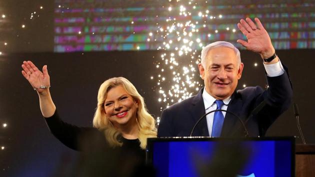 Israeli Prime Minister Benjamin Netanyahu and his wife Sara wave as Netanyahu speaks following the announcement of exit polls in Israel’s parliamentary election at the party headquarters in Tel Aviv, Israel. Netanyahu won a tightly contested election cementing a record fifth term in office. (Ammar Awad / REUTERS) 