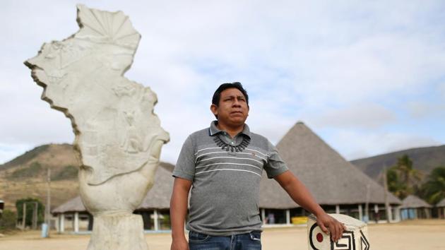 Chief Aldenir Lima, the leader of the 70 communities on the reservation, by a monument made in honour of the tribes people and their struggle to secure land rights. “In the fight for our land rights, 21 of us died,” Lima said. “Since then we recovered what we had lost and today, the white farmers’ rice plantations have been replaced by our cattle herds.” (Bruno Kelly / REUTERS)