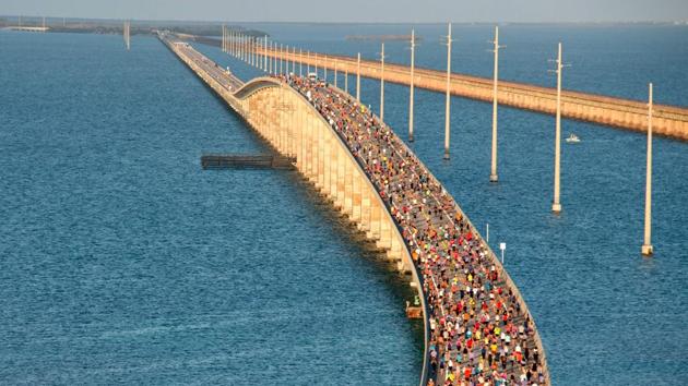 A portion of the field of 1,500 participants begins the trek to the highest point over the Florida Keys Overseas Highway’s longest span during the Seven Mile Bridge Run near Marathon, Florida. (Andy Newman / Florida Keys News Bureau / AFP) 