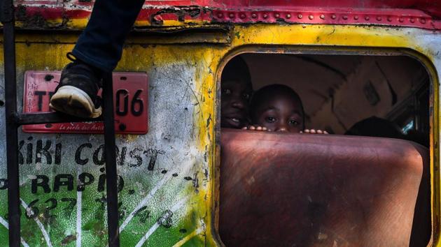 A boy peers from inside a bus in the Haitian capital Port-au-Prince. (Chandan Khanna / AFP) 