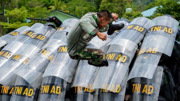 Indonesian soldiers take part in a handling riots practice ahead of the elections at their military home base in Banda Aceh, Indonesia. (Chaideer Manyuddin / AFP) 